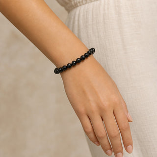 Black Tourmaline bead bracelet worn on the wrist, close-up