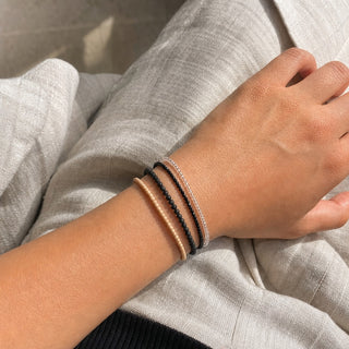 Black Tourmaline bead bracelet stacked with other bead bracelets on the wrist