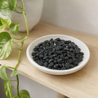 Black Tourmaline Tumbled Stones - Mini in a stoneware dish on a shop shelf