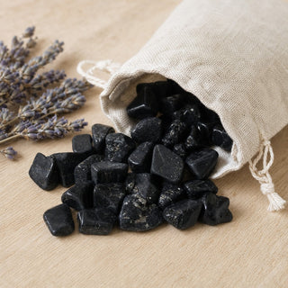 Black Tourmaline Tumbled Stones B - Free Form - 1lb spilling from a linen pouch
