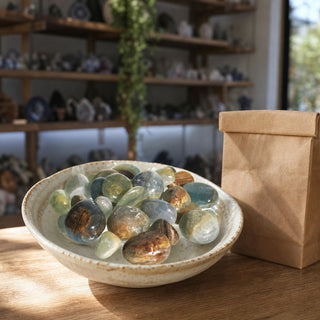 Blue Onyx Tumbled Stones in a ceramic bowl on a shop counter