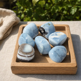 Blue Opal Tumbled Stones - India in a wooden tray at a market stall