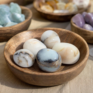 Blue Opal Tumbled Stones in a wooden bowl on a boutique display table
