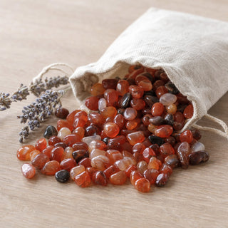 Carnelian Red Agate Tumbled Stones - Mini spilling from a linen pouch