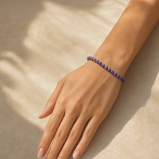 Charoite bead bracelet worn on the wrist, close-up