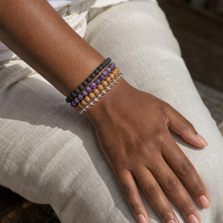 Charoite bead bracelet stacked with other bead bracelets on the wrist