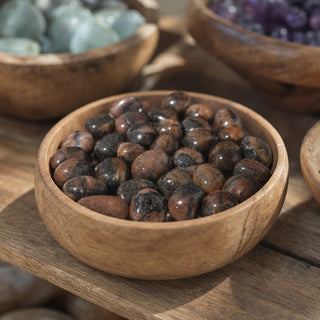 Chiastolite Tumbled Stones in a wooden bowl on a boutique display table