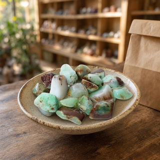 Chrysoprase A Tumbled Stones - Australia in a ceramic bowl on a shop counter