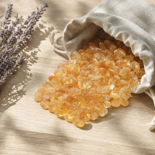 Citrine A Tumbled Stones (Enhanced) spilling from a linen pouch