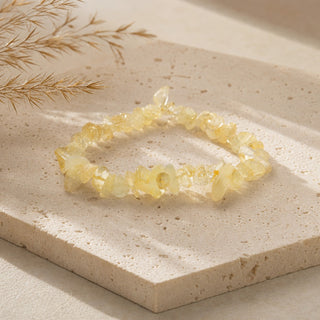 Citrine bead bracelet resting on a stone slab