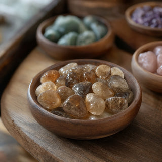 Citrine (Natural) Tumbled Stones in a wooden bowl on a boutique display table