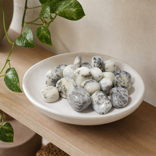 Dendritic Opal Tumbled Stones in a stoneware dish on a shop shelf