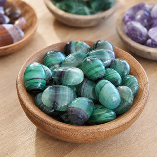 Fluorite Rainbow Tumbled in a wooden bowl on a boutique display table