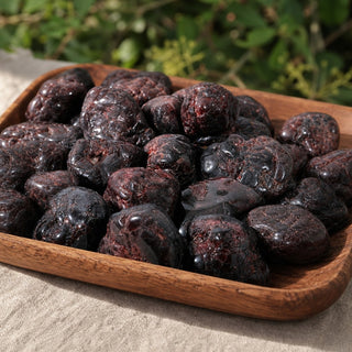 Garnet A Tumbled Stone - Free Form - 1lb in a wooden tray at a market stall