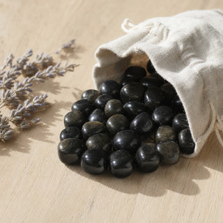 Gold Sheen Obsidian Tumbled Stones - Mexico spilling from a linen pouch