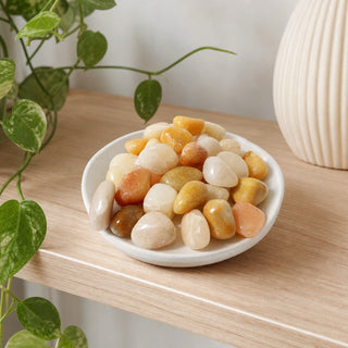 Golden Quartz Tumbled Stones in a stoneware dish on a shop shelf