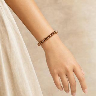 Copper Hematite bead bracelet worn on the wrist, close-up