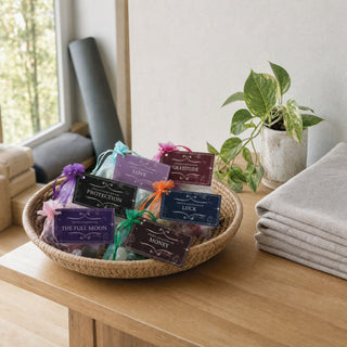 Intention Crystal Collection kits in a woven basket on a yoga studio reception counter