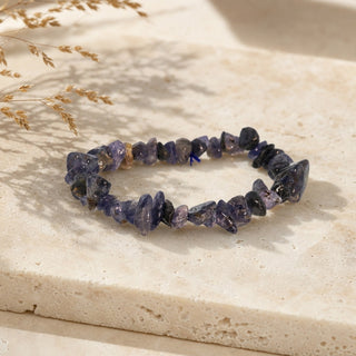 Iolite bead bracelet resting on a stone slab