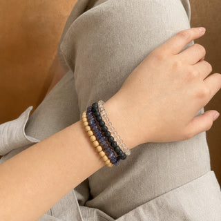 Iolite bead bracelet stacked with other bead bracelets on the wrist
