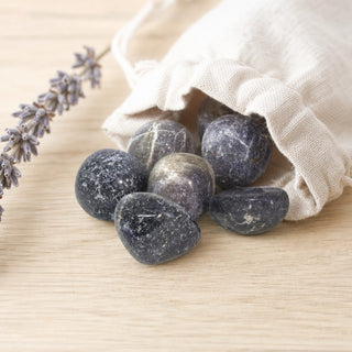 Iolite Tumbled Stones - India spilling from a linen pouch