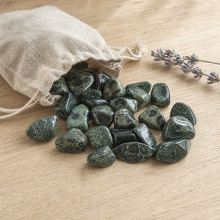 Kambaba Jasper Tumbled Stones spilling from a linen pouch