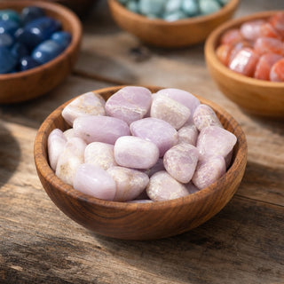 Kunzite A Tumbled Stones in a wooden bowl on a boutique display table