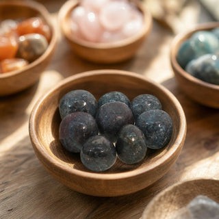 Ruby Kyanite Tumbled Stones - India in a wooden bowl on a boutique display table