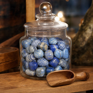 Lapis Lazuli B Tumbled Stones in a glass apothecary jar with a scoop