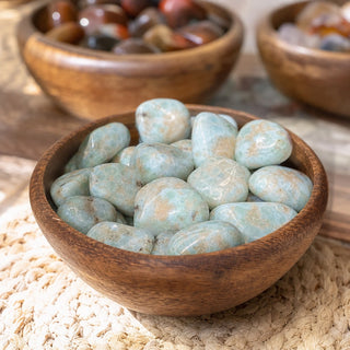 Larimar Tumbled Semi-Polished - Single #1 (6g to 20g, 1/4" to 1 1/2") in a wooden bowl on a boutique display table