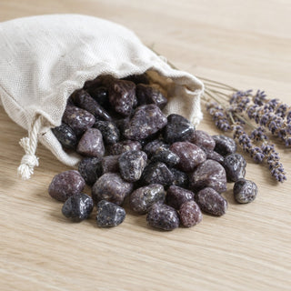 Lepidolite Semi-Polished Tumbled Stones spilling from a linen pouch
