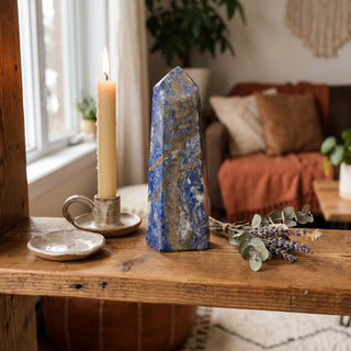 Sodalite Generator Unique #33 displayed on a wooden home altar shelf beside a candle, shown at true size in warm natural light.