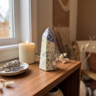 Sodalite Generator Unique #22 displayed on a wooden home altar shelf beside a candle, shown at true size in warm natural light.