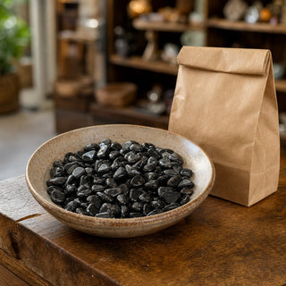Lodestone Tumbled Stones in a ceramic bowl on a shop counter