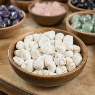 Magnesite Nugget Tumbled Stones in a wooden bowl on a boutique display table