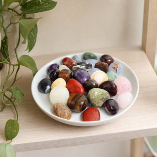 Mixed Natural Tumbled Stones in a stoneware dish on a shop shelf