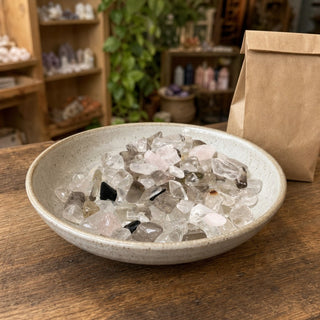 Mixed Tumbled Stones - Assorted in a ceramic bowl on a shop counter