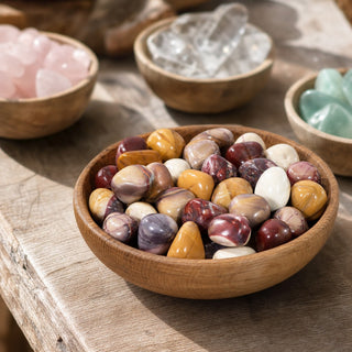 Mookaite Jasper B Tumbled Stones in a wooden bowl on a boutique display table