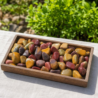 Mookaite Jasper E Tumbled Stones in a wooden tray at a market stall