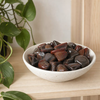 Mugglestone Tumbled Stones in a stoneware dish on a shop shelf