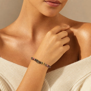 Multi-Colour Tourmaline bead bracelet worn with the fingertips resting at the collarbone