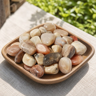 Multicolour Moonstone Tumbled Stones in a wooden tray at a market stall