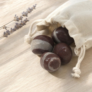 Narmada Shiva Lingam Tumbles Stone spilling from a linen pouch