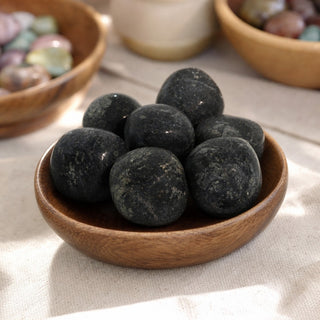 Nuummite Tumbled Stones - India in a wooden bowl on a boutique display table