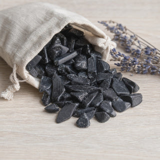 Obsidian Black Tumbled Stones - Semi Polished spilling from a linen pouch