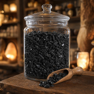 Black Obsidian Tumbled Stones in a glass apothecary jar with a scoop