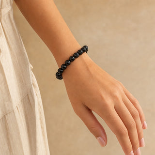 Black Onyx bead bracelet worn on the wrist, close-up