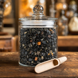 Black Onyx Tumbled Stones - Assorted Tiny in a glass apothecary jar with a scoop