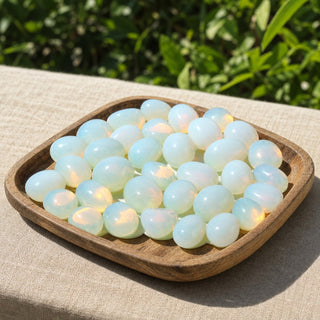 Opalite Tumbled Stones (Synthetic) in a wooden tray at a market stall