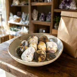 Orbicular Jasper Tumbled Stones - India in a ceramic bowl on a shop counter